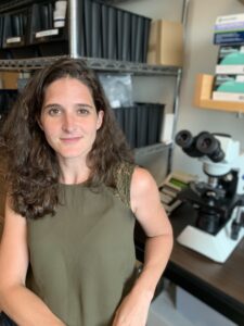 image of Sabrina Absalon in front of a microscope