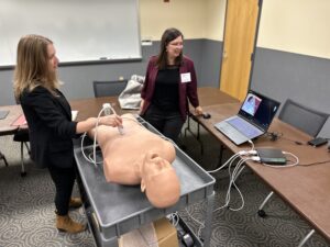 Kara Garcia, PhD, and Ellen Ireland, PhD, demonstrate PoCUS technology for attendees in Terre Haute.