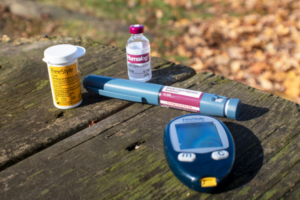 diabetic testing supplies laying on a picnic table