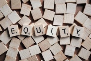 scrabble tiles with equity spelled out