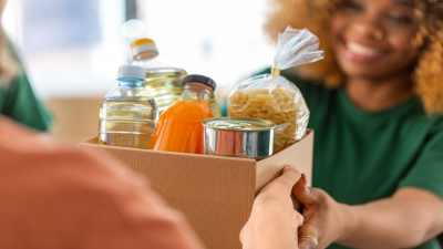 hands holding a box of food